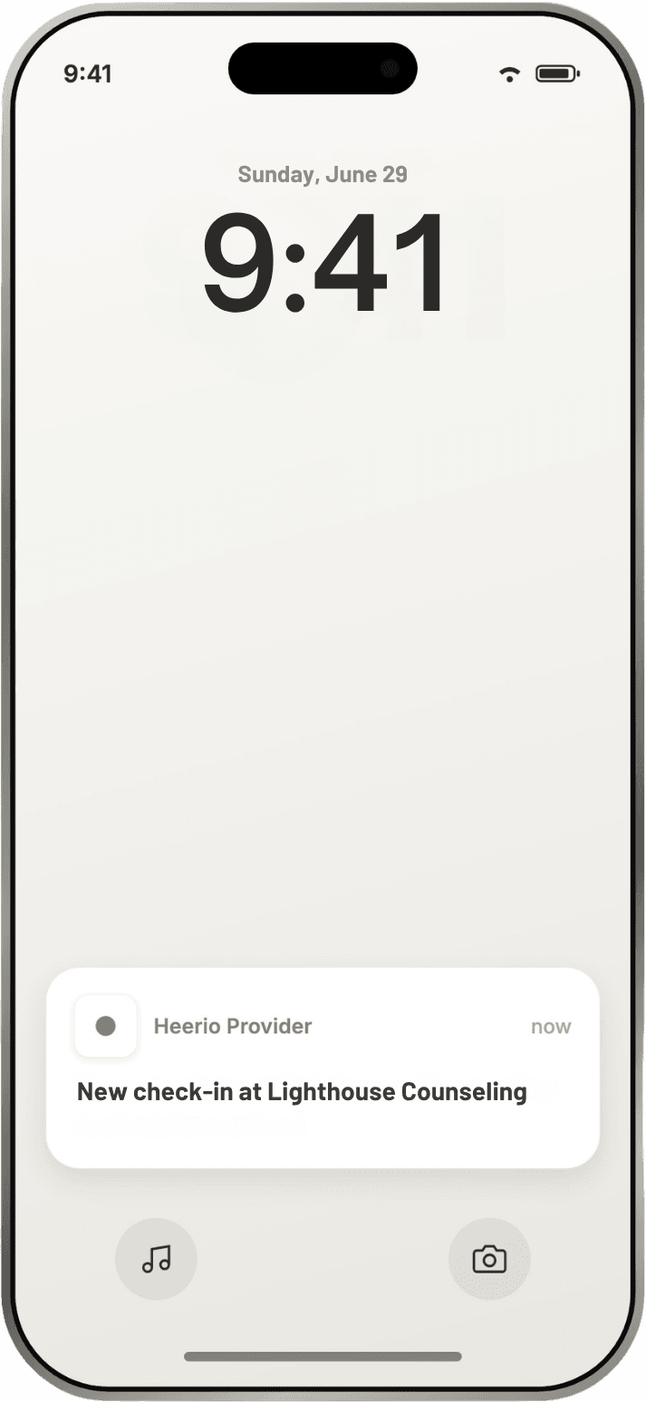 iPhone lock screen with a Heerio push notification: new check-in at Lighthouse Counseling, a client has arrived